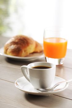 Breakfast, coffee, Croissant and Orange juice  on wooden table