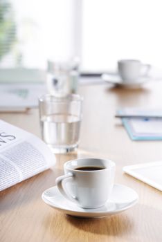 Business Office scene, Coffee, newspaper, water glass on meeting desk