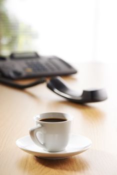 Business Office scene, cup of coffee and telephone on desk