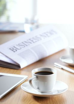 Business Office scene, digital tablet and newspaper with coffee 