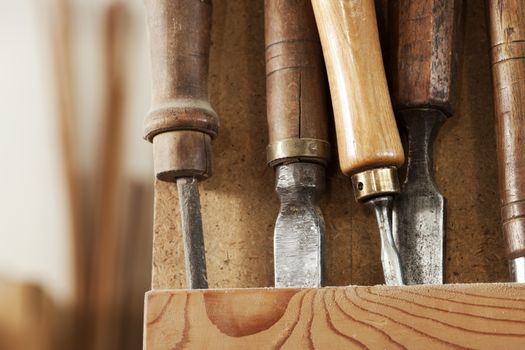 Set of carpenter tools on a wooden rack.