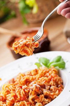 Italian food: pasta with tomato sauce and parmesan cheese.