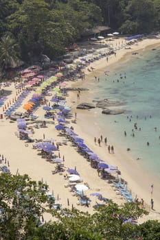 PHUKET, THAILAND-FEBRUARY 20TH 2014: Tourists at Laem Singh beach on Phuket. The beach is a favourite with younger tourists who often travel from Patong on motorbikes.