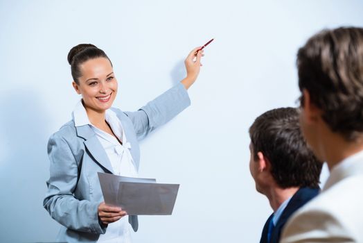 image of a Business woman showing a presentation to colleagues