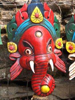 red mask of Ganes on open market in Nepal         