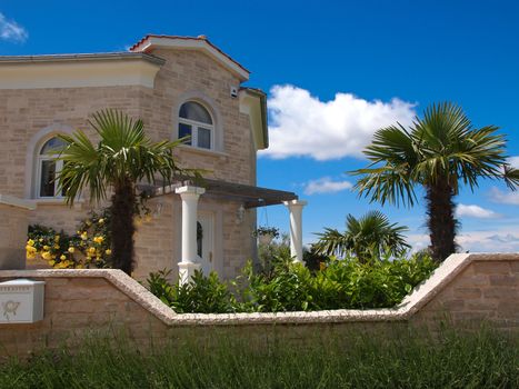 stone house and palm tree