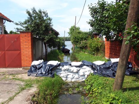 White sandbags for flood defense and brown water       