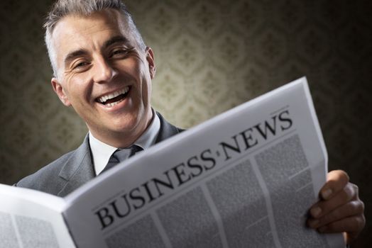 Handsome businessman reading news against vintage wallpaper background.