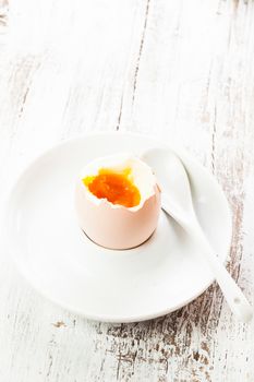 The soft-boiled egg in an eggcup with spoon