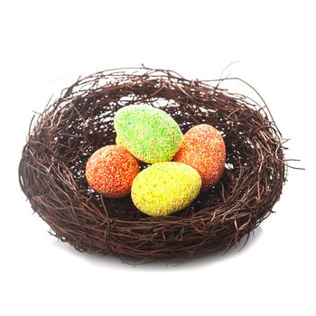 Decorative nest with eggs isolated on white. Easter decor.