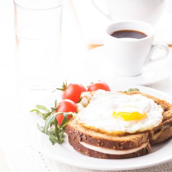 Breakfast with coffee, Croque Madame sandwich close up