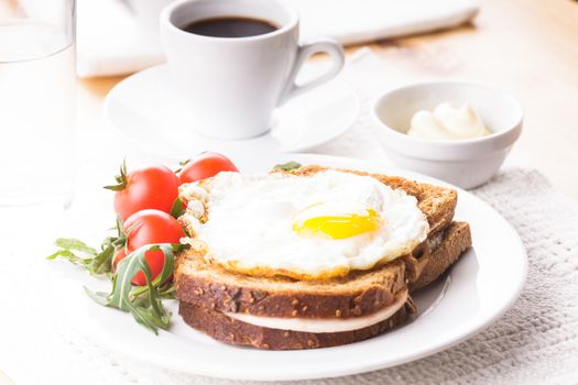 Breakfast with coffee, Croque Madame sandwich close up