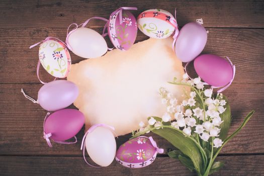Purple and white eggs and empty greeting card. Easter decorations