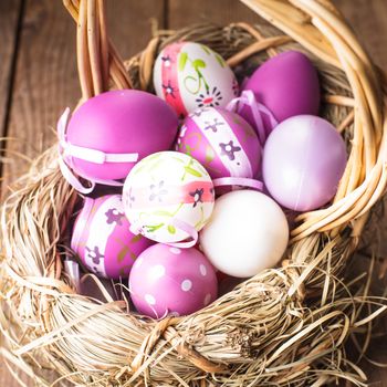 Various purple eggs in basket, Easter decorations