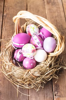 Various purple eggs in basket, Easter decorations