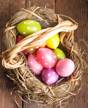 Colorful polka dot eggs in basket, Easter decorations