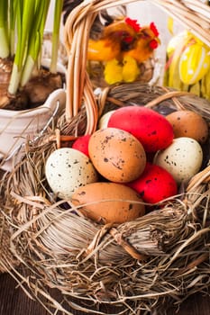 Brown, red and yellow eggs in basket, Easter decor