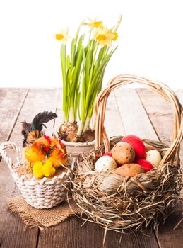 Pink and yellow eggs in basket, Easter decorations on white background