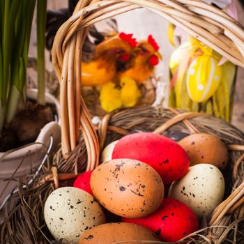 Brown, red and yellow eggs in basket, Easter decor