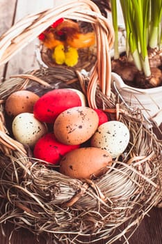 Brown, red and yellow eggs in basket, Easter decor