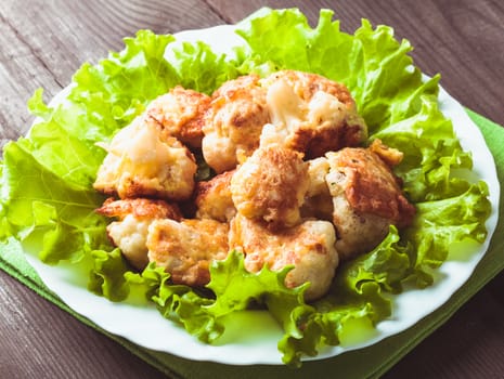 Fried cauliflower closeup on the plate on a table