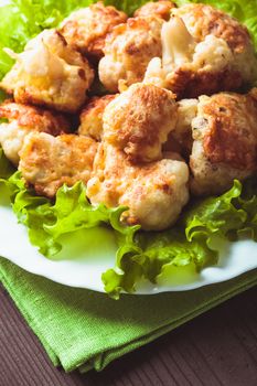 Fried cauliflower closeup on the plate on a table