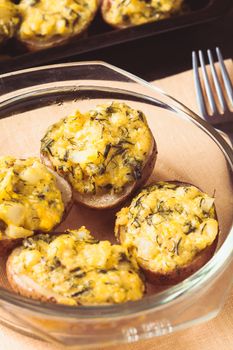 Stuffed baked potato with eggs, cheese and spices