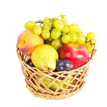 Autumnal fruits in the basket isolated on white
