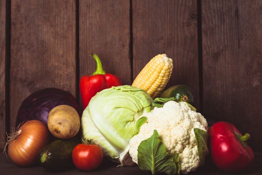 Still life of vegetables on the wood background closeup