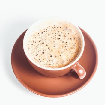 Coffee cup with crema on a white background