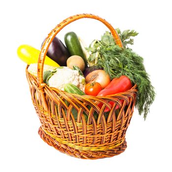 Basket with vegetables and fresh herbs isolated on white