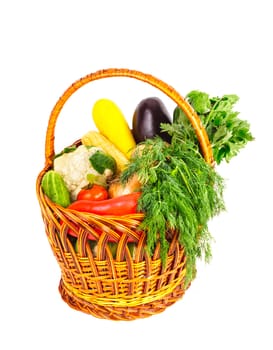 Basket with vegetables and fresh herbs isolated on white