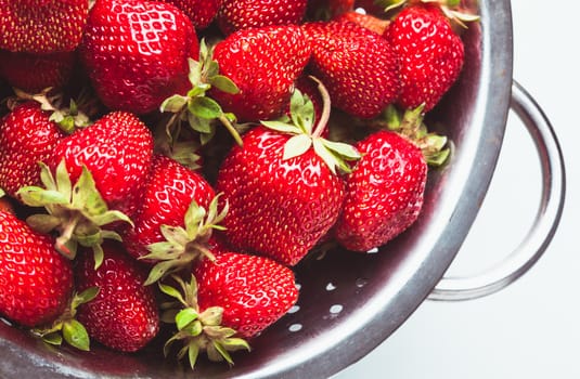 Strawberry berries close up as in a colander