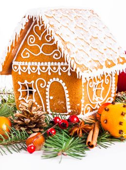 gingerbread house with christmas decorations on a white backgrond