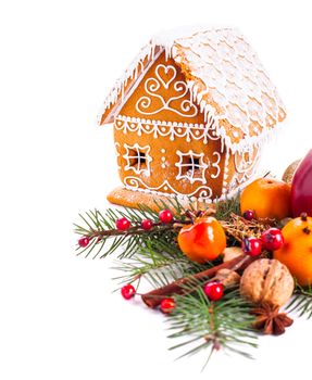 gingerbread house with christmas decorations on a white backgrond