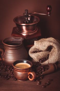 Coffee still life in rustic style over brown background