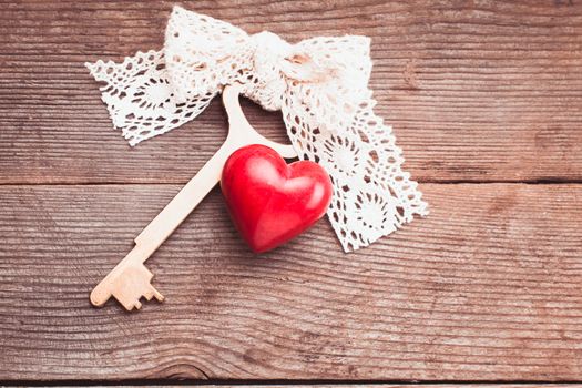 Old intage key and red heart. Key of my heart concept. Valentine's day greetings.