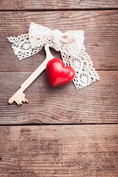 Old intage key and red heart. Key of my heart concept. Valentine's day greetings.