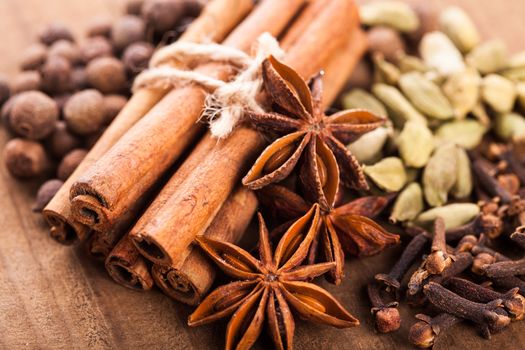 Collection of spices for mulled wine and pastry on the wooden table