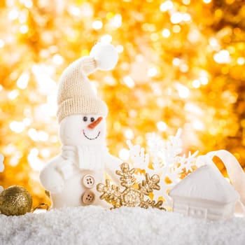 Snowman over gold bokeh - christmas background for design