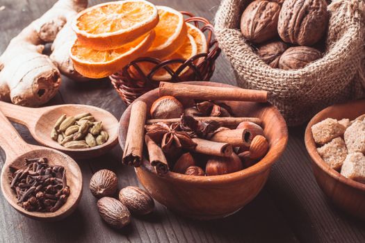 Christmas spices - nuts, brown sugar, dried orange, kandamon, cloves, cinnamon, nutmeg, ginger and anise