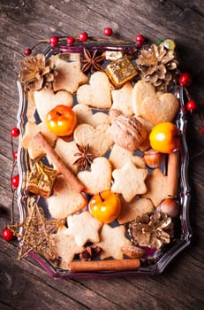 Christmas sweet decor - cookies, apple and spices on the tray