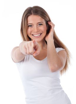 Portrait of a smiling woman pointing in front of her,  isolated on white