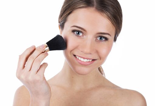 Close up portrait of a beautiful girl applying makeup, isolated on white