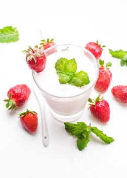 Strawberry yoghurt in glass on the white table