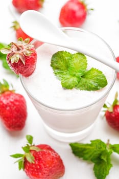 Strawberry yoghurt in glass on the white table