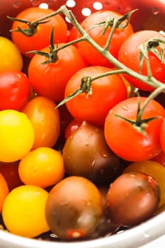 Various types of cherry tomatoes in colander