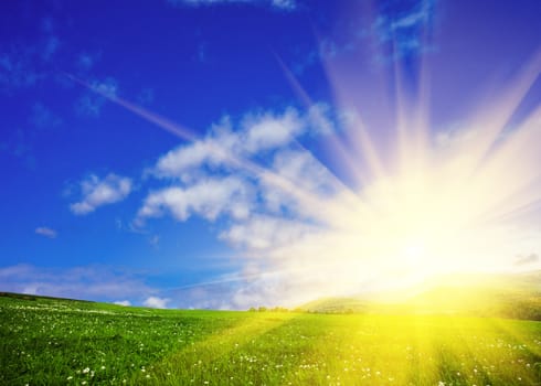 Green meadows and  blue sky with sunshine. Nature background