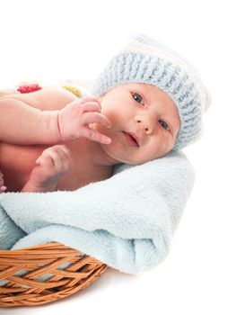 Newborn baby boy in the crochet hat lay in basket