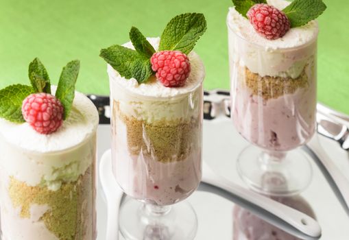Dessert with raspberry and curd mousse with mint leaves